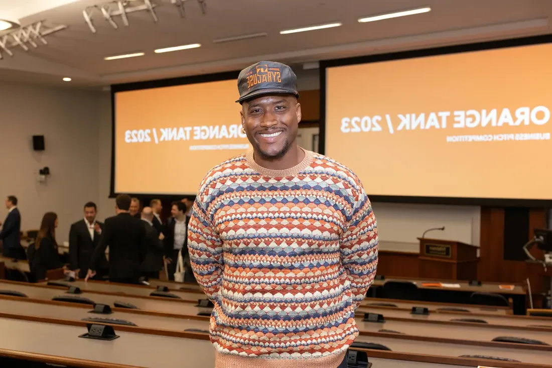 Person standing in front of a presentation room.